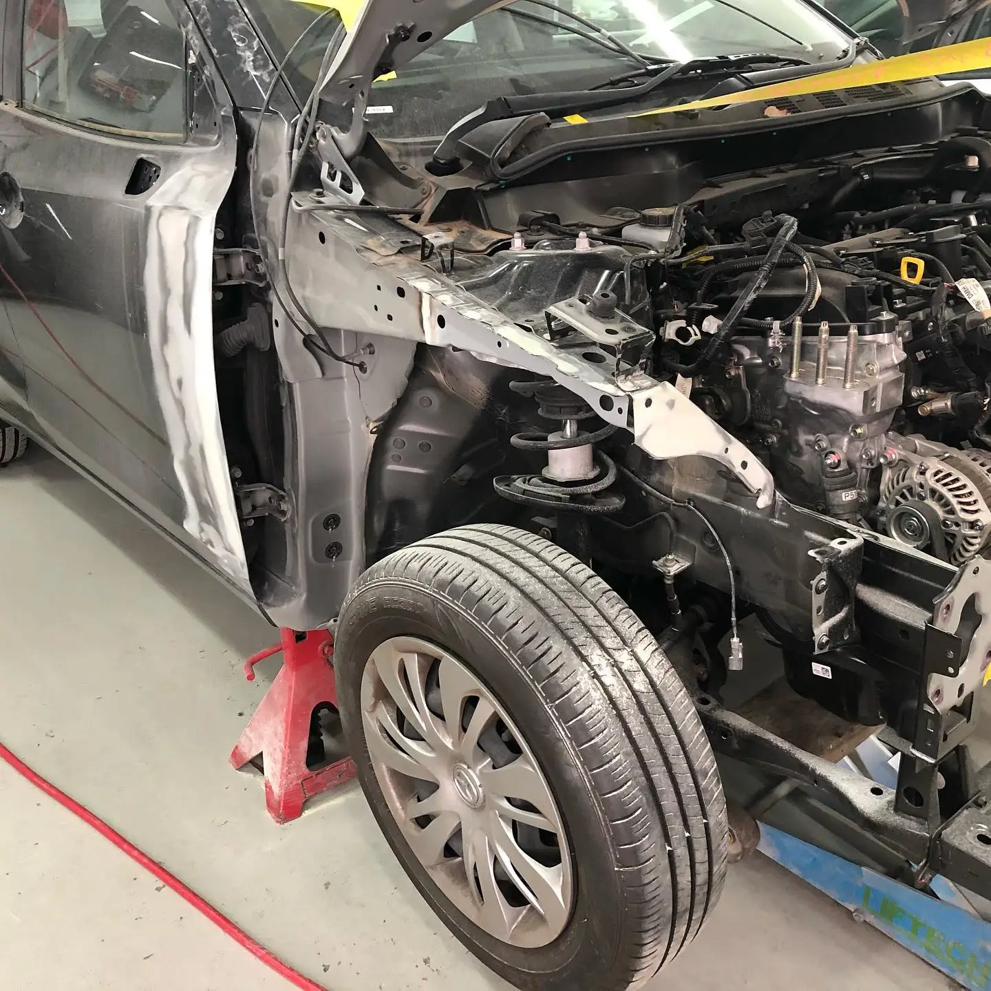 Technician welding a replacement auto body panel