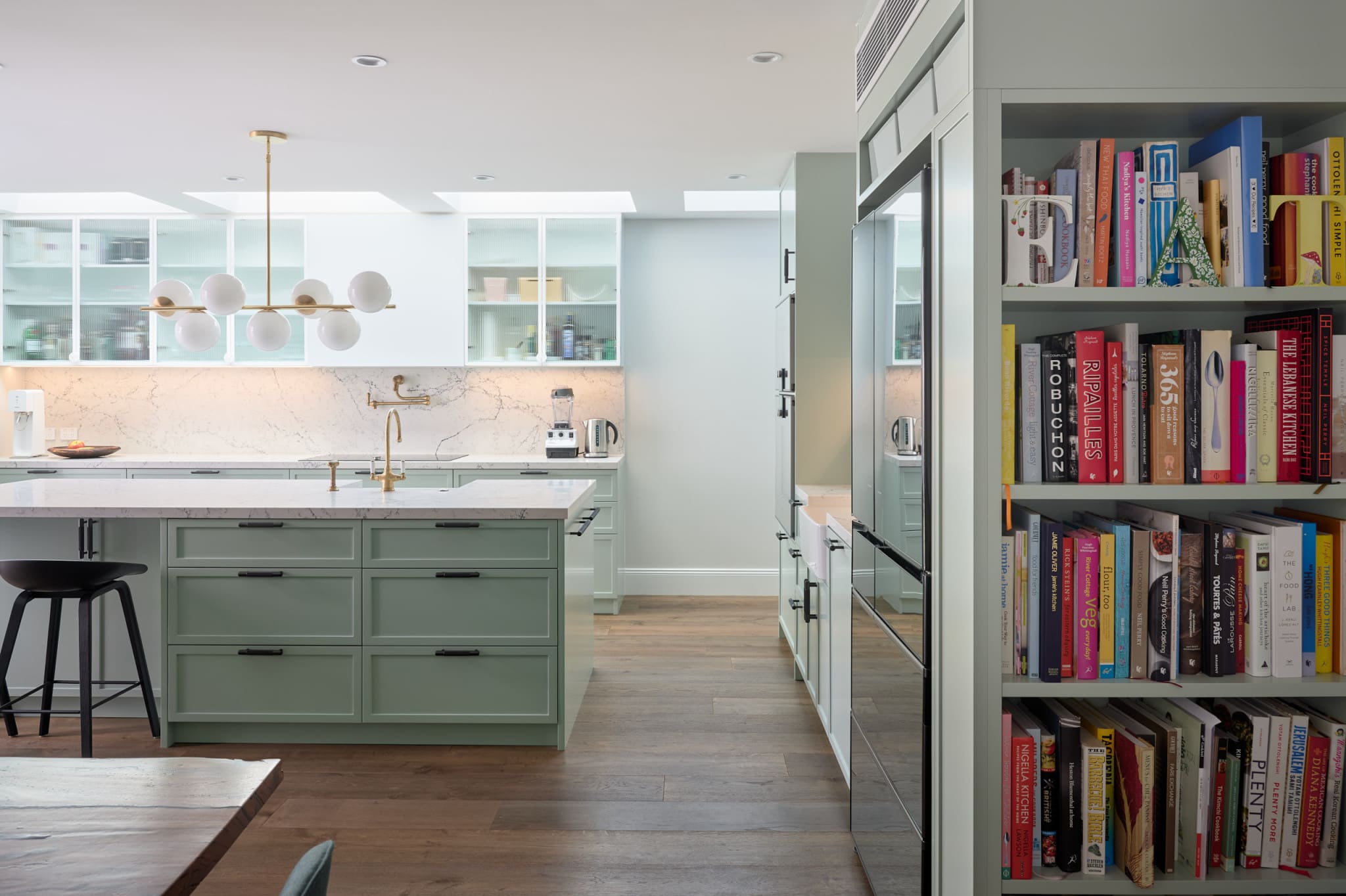 Close-up of premium shaker-style custom kitchen cabinets with matte black hardware and custom paint finish