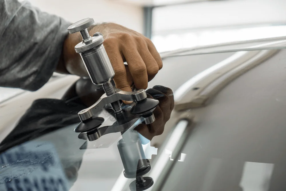 Vehicle secured on heavy-duty body realignment machine