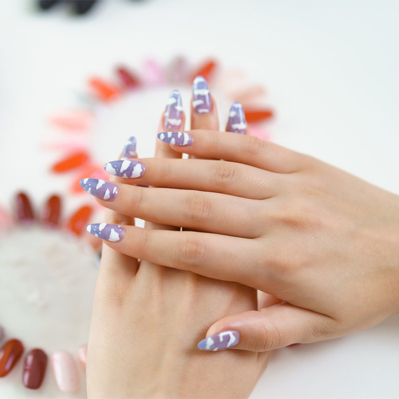 Beautiful manicure on color palette background